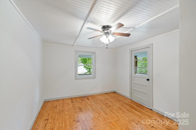 spare room with visible vents, crown molding, light wood-style flooring, and baseboards