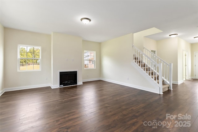 1034 Heath Helms Rd, Monroe, NC 28110 - unfurnished living room featuring healthy amount of natural light, stairway, dark wood-style floors, and a fireplace