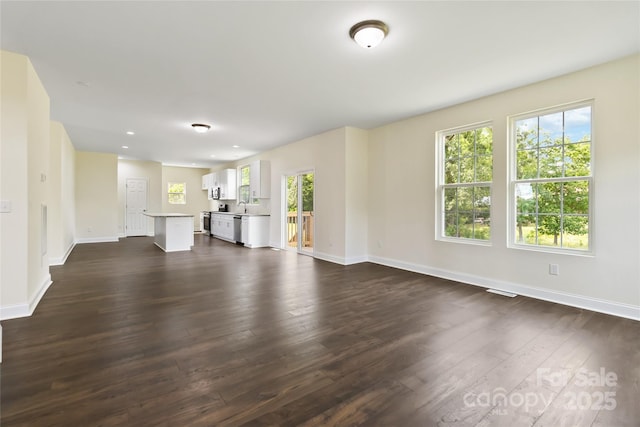 1034 Heath Helms Rd, Monroe, NC 28110 - unfurnished living room featuring dark wood-style flooring and recessed lighting