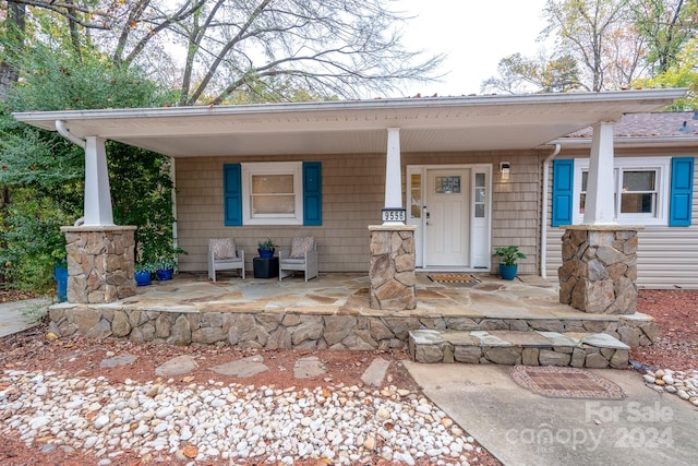 doorway to property featuring a porch