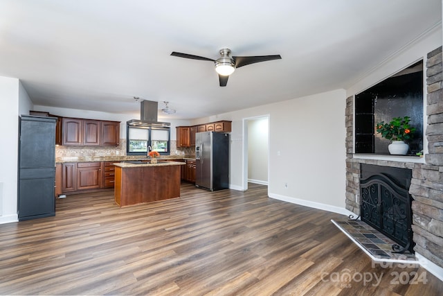 kitchen featuring dark hardwood / wood-style flooring, tasteful backsplash, a kitchen island, and stainless steel fridge with ice dispenser