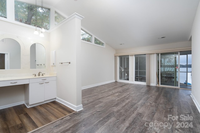 bathroom with wood-type flooring, vanity, and high vaulted ceiling