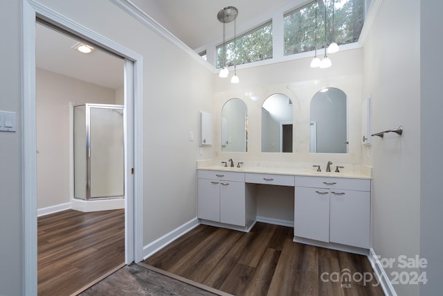 bathroom featuring hardwood / wood-style floors, vanity, and crown molding