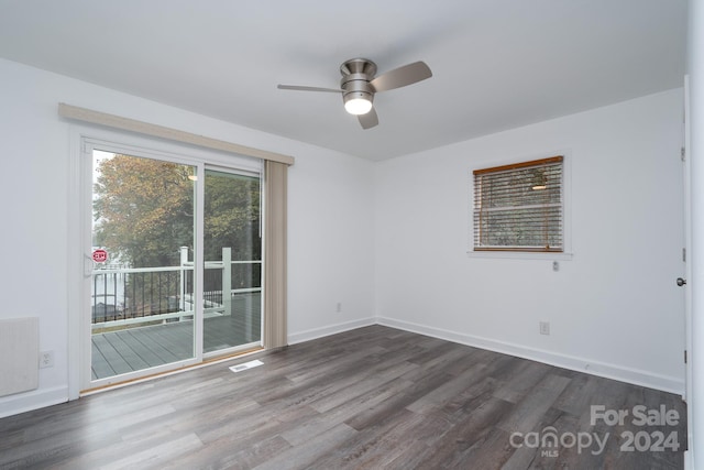 empty room with ceiling fan and dark hardwood / wood-style floors