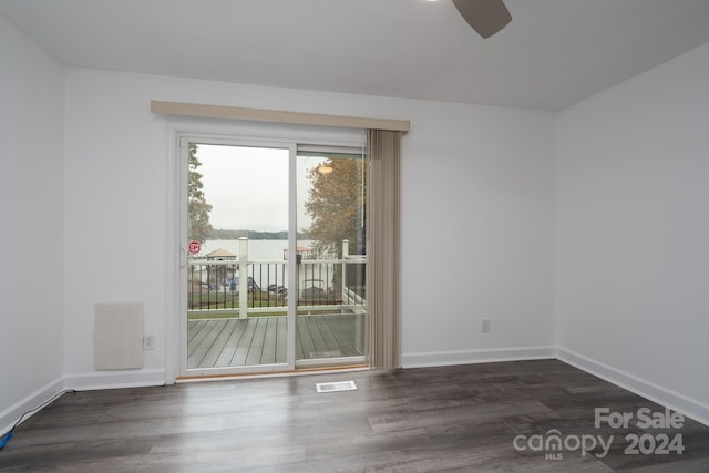 unfurnished room with ceiling fan and dark hardwood / wood-style floors