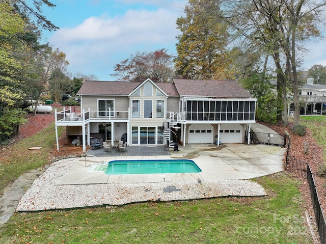 back of house featuring a patio area, a sunroom, and a swimming pool side deck