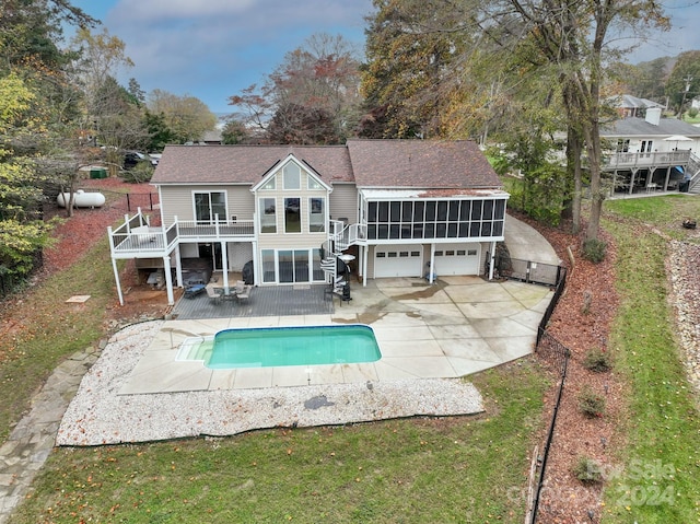 back of property with an outbuilding, a pool side deck, and a patio area