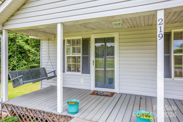 wooden terrace featuring covered porch