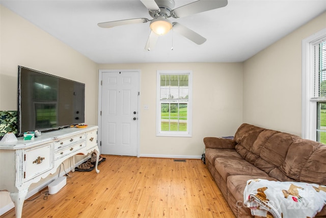 living room featuring plenty of natural light, light hardwood / wood-style flooring, and ceiling fan