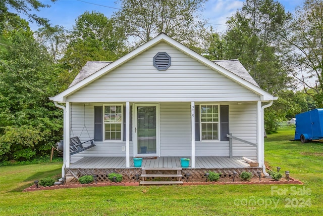 bungalow-style home with a front lawn and a porch