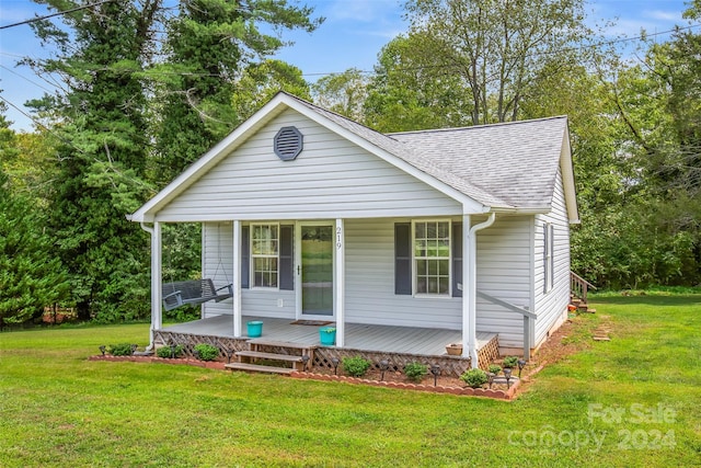 bungalow-style home with covered porch and a front lawn