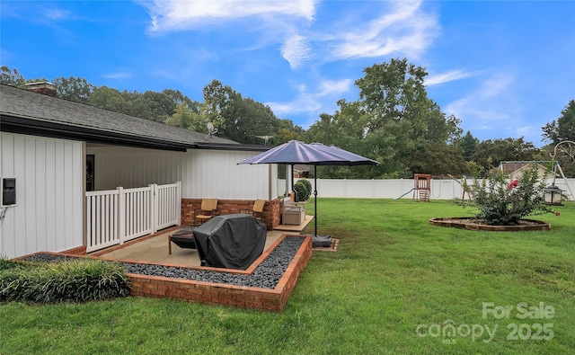 view of yard featuring a playground, a patio area, and an outdoor living space