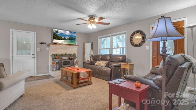 living room with ceiling fan and a textured ceiling