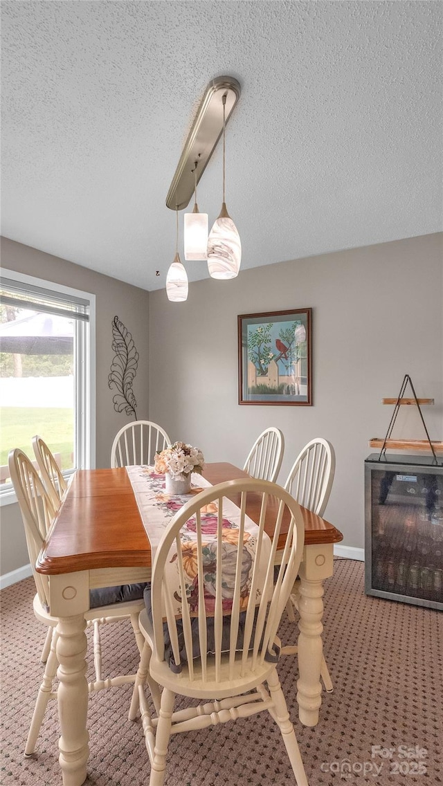 dining area with carpet flooring and a textured ceiling