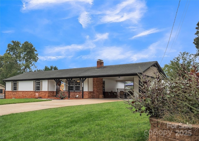 view of front of house with a front yard and a carport