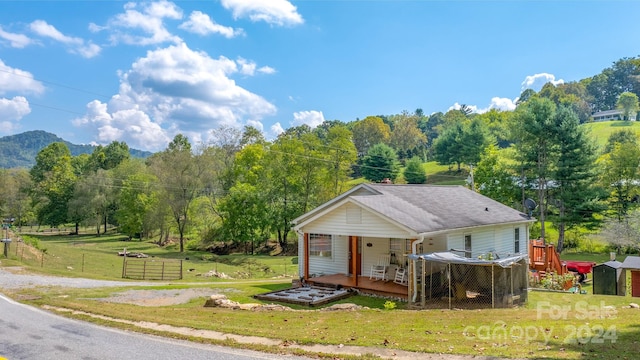 view of front of house featuring a front yard and a deck