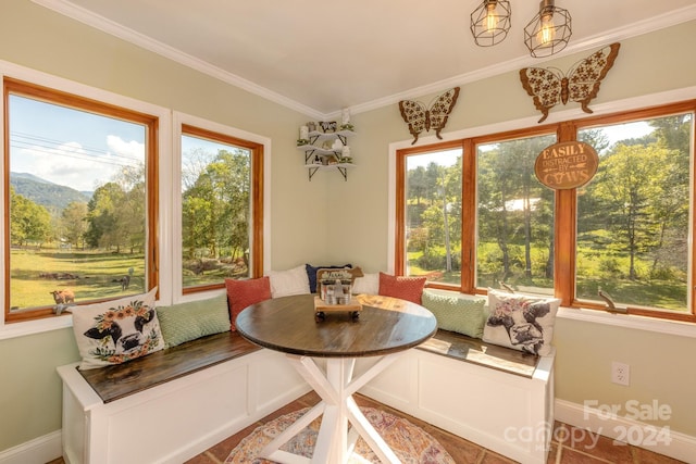 dining space featuring crown molding and breakfast area