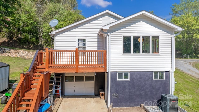 rear view of property with central AC, a deck, and a garage