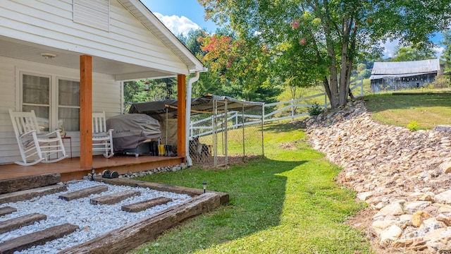 view of yard featuring a wooden deck and fence