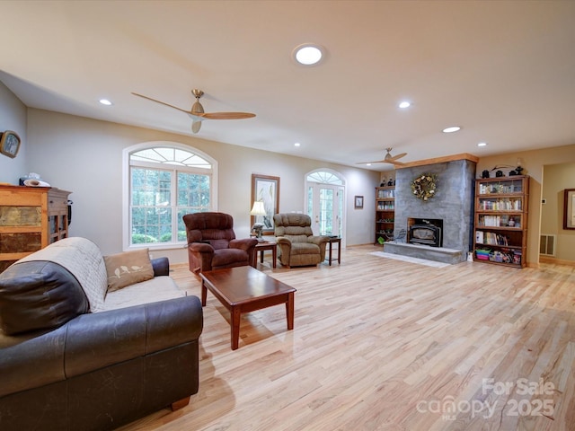 living area with a ceiling fan, recessed lighting, visible vents, and light wood-style flooring