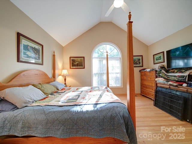 bedroom with light wood-style floors, vaulted ceiling, and a ceiling fan