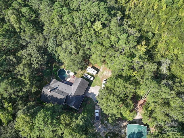 drone / aerial view featuring a forest view