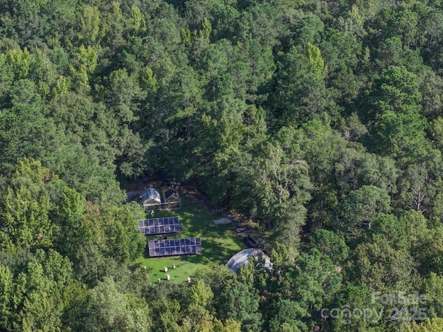 drone / aerial view with a wooded view