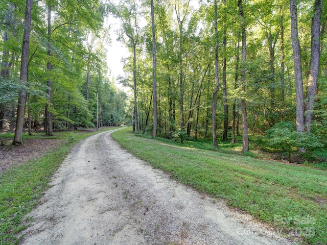 view of road with a forest view