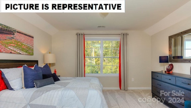 bedroom with lofted ceiling and light carpet