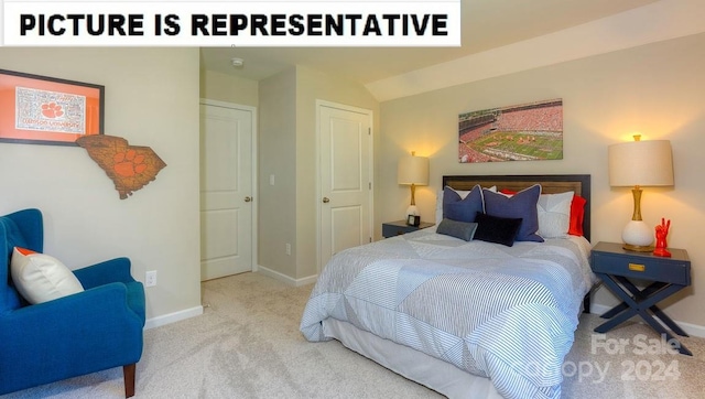 carpeted bedroom with vaulted ceiling