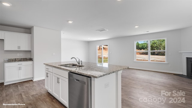 kitchen with dishwasher, a healthy amount of sunlight, a kitchen island with sink, and white cabinets