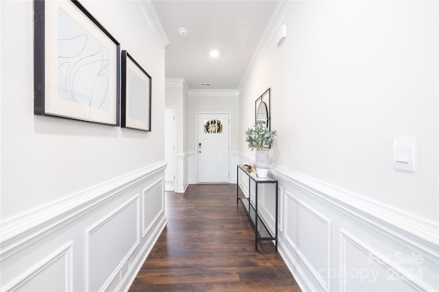 corridor with dark wood-type flooring and crown molding