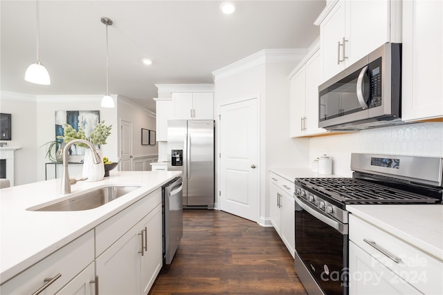 kitchen with appliances with stainless steel finishes, decorative light fixtures, dark hardwood / wood-style flooring, sink, and white cabinets