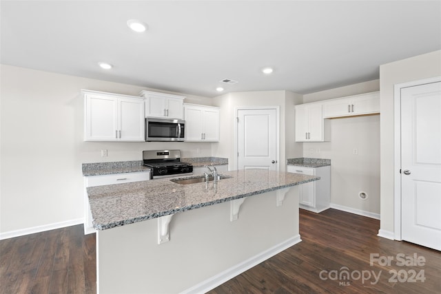 kitchen featuring a kitchen island with sink, appliances with stainless steel finishes, white cabinetry, and sink