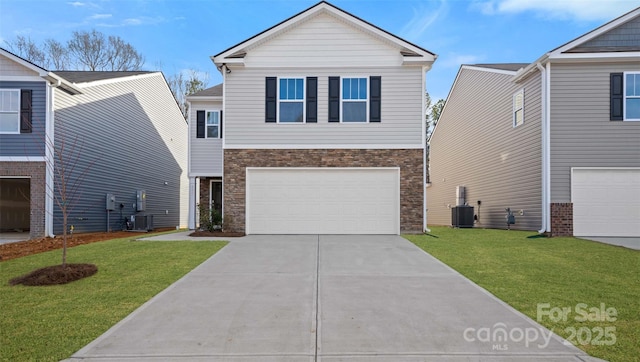 view of front of house featuring driveway, a garage, central AC unit, and a front yard