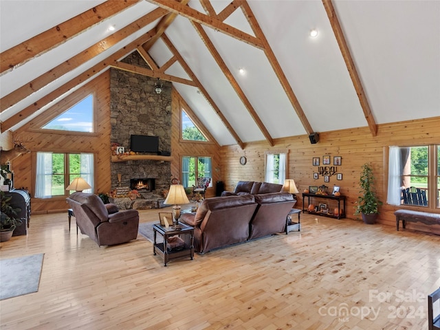 living room featuring light hardwood / wood-style floors and high vaulted ceiling