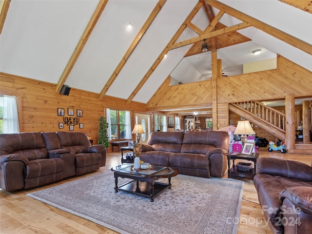 living room with beamed ceiling, high vaulted ceiling, light hardwood / wood-style floors, and plenty of natural light