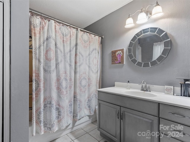 bathroom featuring tile patterned flooring, vanity, and shower / bath combo