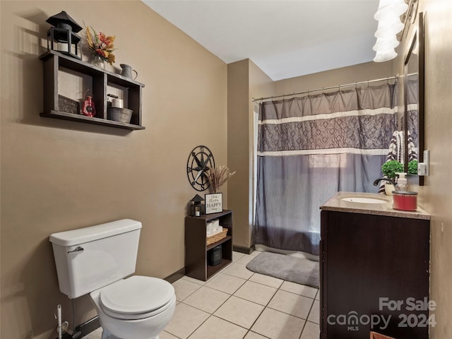 bathroom featuring tile patterned floors, a shower with curtain, vanity, and toilet