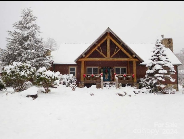 log home featuring a porch