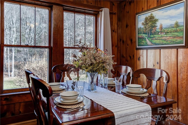 dining space with wooden walls