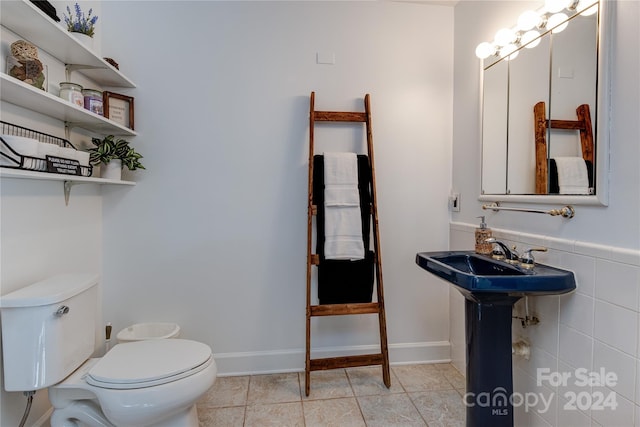 bathroom with sink, tile patterned flooring, and toilet