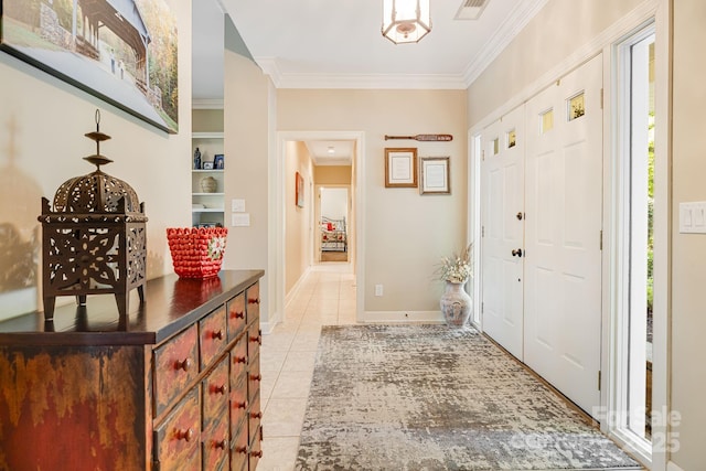 entrance foyer with light tile patterned floors and ornamental molding