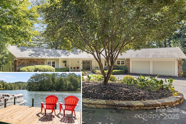 exterior space featuring a garage and a water view