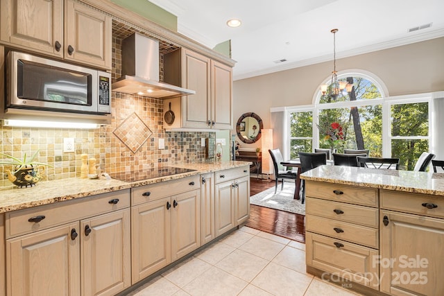 kitchen with wall chimney exhaust hood, decorative light fixtures, light tile patterned floors, black electric cooktop, and ornamental molding