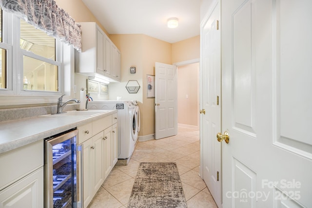 kitchen featuring white cabinets, separate washer and dryer, sink, and wine cooler