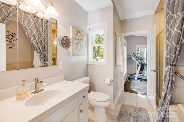 bathroom with tile patterned flooring, vanity, crown molding, and toilet