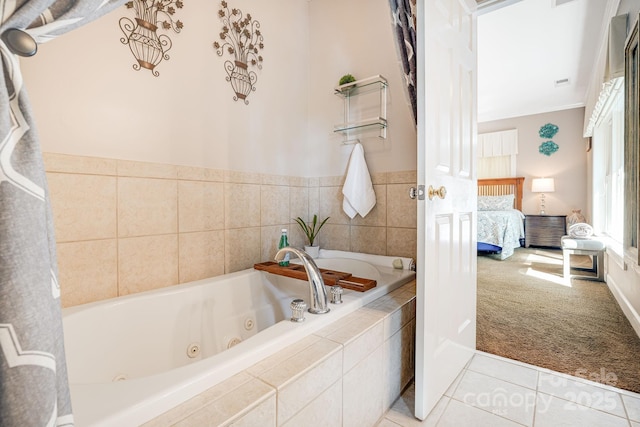 bathroom featuring tile patterned flooring and tiled tub