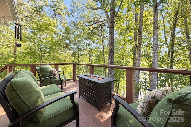 wooden terrace with an outdoor fire pit