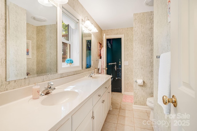 bathroom featuring vanity, tile patterned floors, and toilet